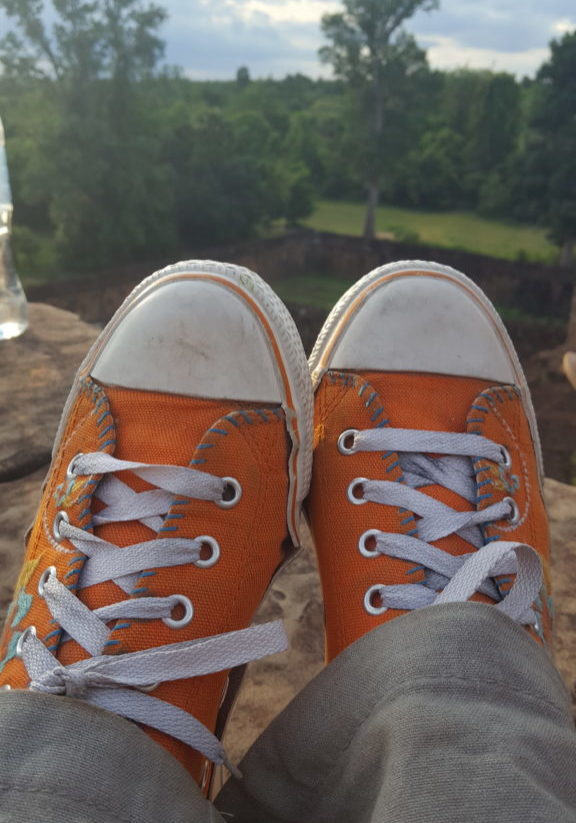 Orange shoes overlooking a forest in Cambodia